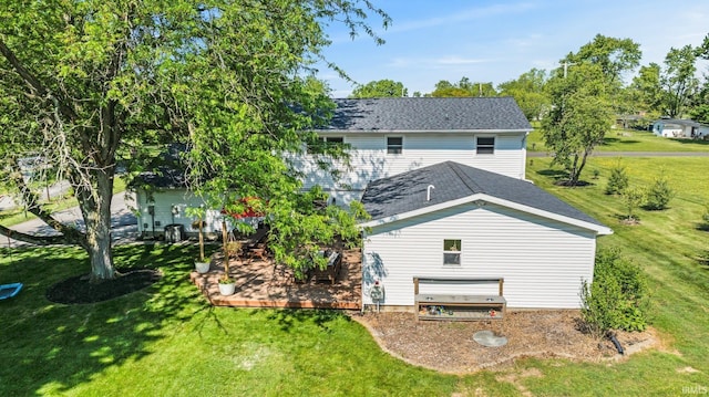 1229 Dell Cove Dr, Fort Wayne, IN 46804 - rear view of property featuring a yard, roof with shingles, and a wooden deck