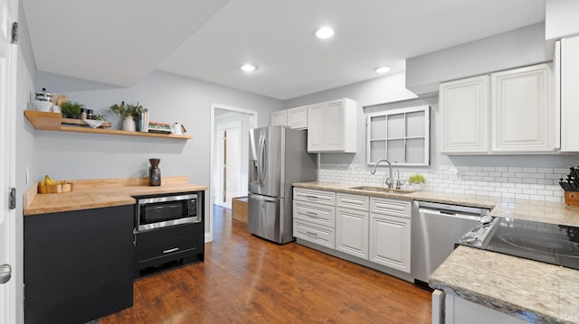 1229 Dell Cove Dr, Fort Wayne, IN 46804 - kitchen with a sink, stainless steel appliances, open shelves, decorative backsplash, and dark wood-style flooring