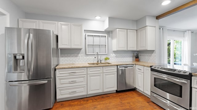 1229 Dell Cove Dr, Fort Wayne, IN 46804 - kitchen featuring appliances with stainless steel finishes, a sink, white cabinetry, light stone countertops, and recessed lighting