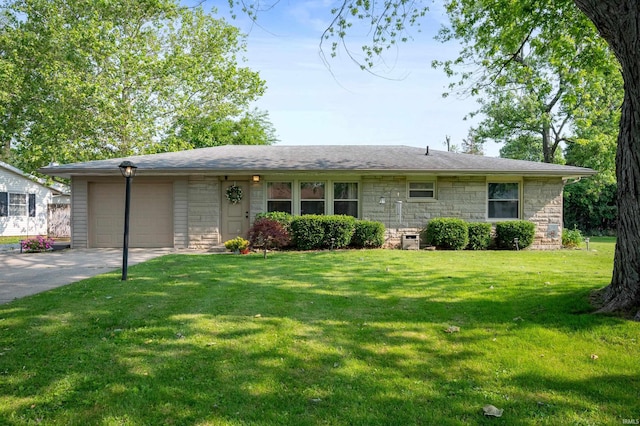 2408 W Sheffield Dr, Muncie, IN 47304 - view of front of house featuring a garage, stone siding, driveway, and a front lawn