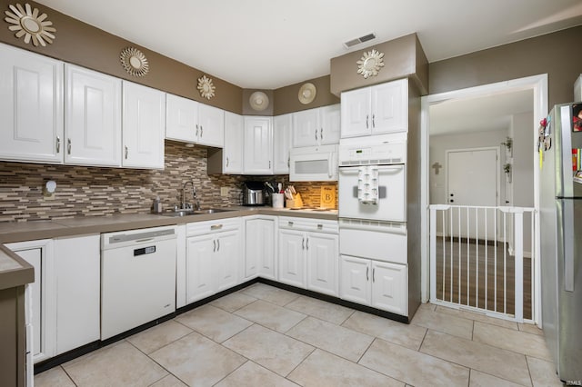 2408 W Sheffield Dr, Muncie, IN 47304 - kitchen with white appliances, a sink, decorative backsplash, white cabinets, and light tile patterned flooring