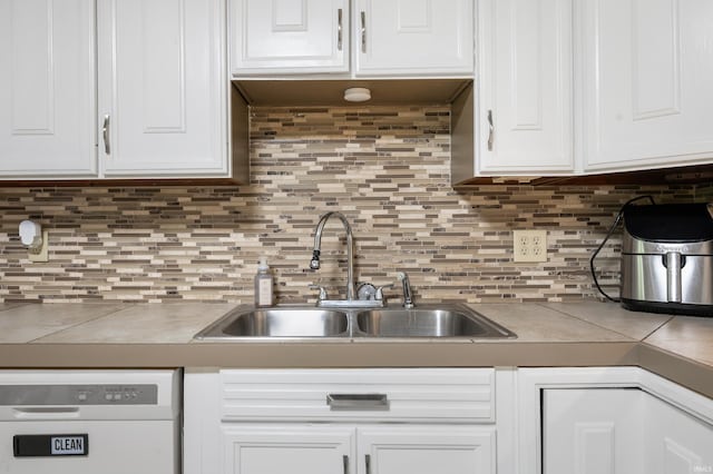 2408 W Sheffield Dr, Muncie, IN 47304 - kitchen with dishwasher, a sink, white cabinets, and backsplash