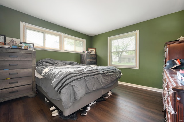 2408 W Sheffield Dr, Muncie, IN 47304 - bedroom featuring multiple windows, dark wood-type flooring, and baseboards
