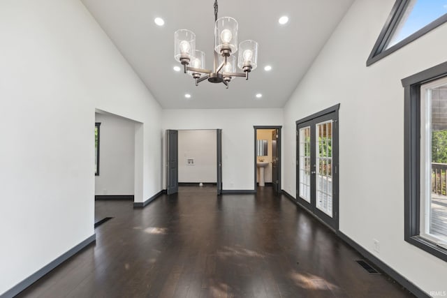 6226 Wheeling Ave, Muncie, IN 47304 - spare room featuring high vaulted ceiling, healthy amount of natural light, a chandelier, dark wood-style floors, and recessed lighting