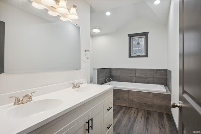 6226 Wheeling Ave, Muncie, IN 47304 - full bath with a bath, wood finished floors, double vanity, vaulted ceiling, and recessed lighting