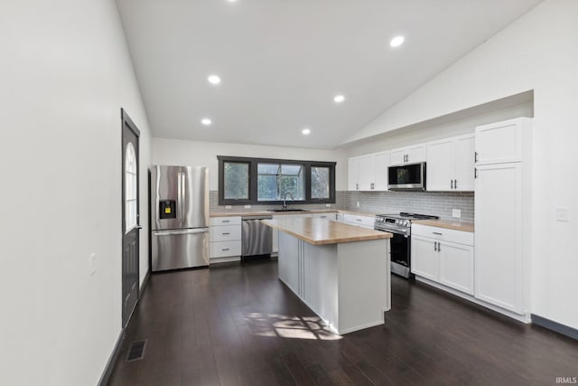 6226 Wheeling Ave, Muncie, IN 47304 - kitchen featuring appliances with stainless steel finishes, butcher block counters, white cabinets, decorative backsplash, and recessed lighting