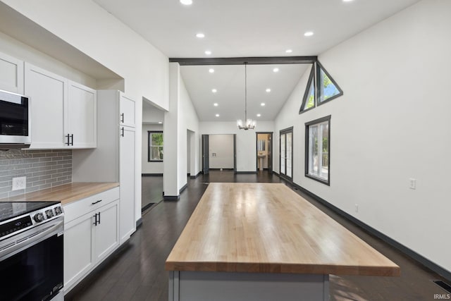 6226 Wheeling Ave, Muncie, IN 47304 - kitchen with wooden counters, appliances with stainless steel finishes, a chandelier, white cabinetry, and high vaulted ceiling