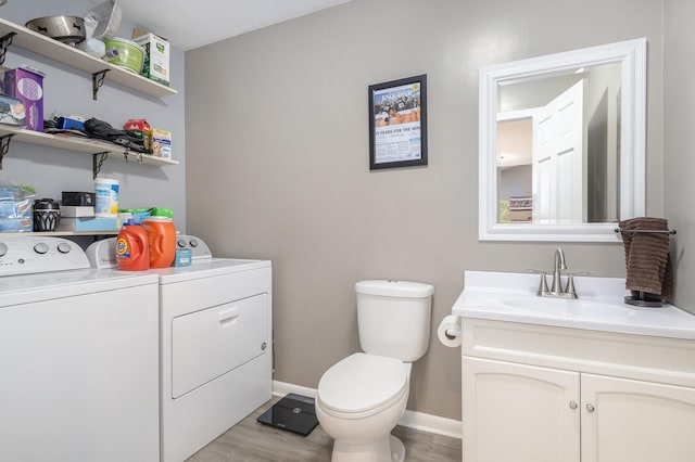 5206 Windfall Ct, South Bend, IN 46619 - half bath with separate washer and dryer, vanity, wood finished floors, toilet, and baseboards