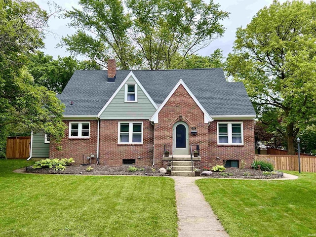 1500 N Grant St, West Lafayette, IN 47906 - tudor-style house featuring a shingled roof, brick siding, and a chimney