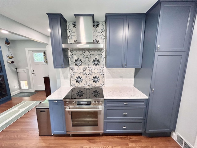 1500 N Grant St, West Lafayette, IN 47906 - kitchen featuring stainless steel electric range, wall chimney range hood, decorative backsplash, and wood finished floors