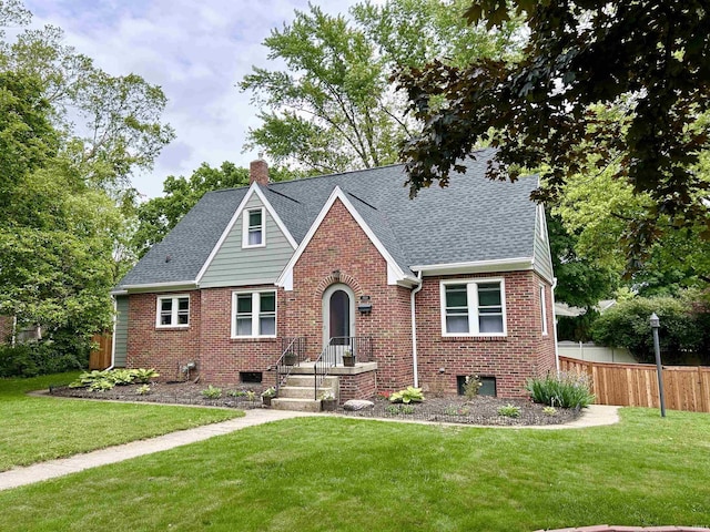 1500 N Grant St, West Lafayette, IN 47906 - tudor house with brick siding, a chimney, and a shingled roof