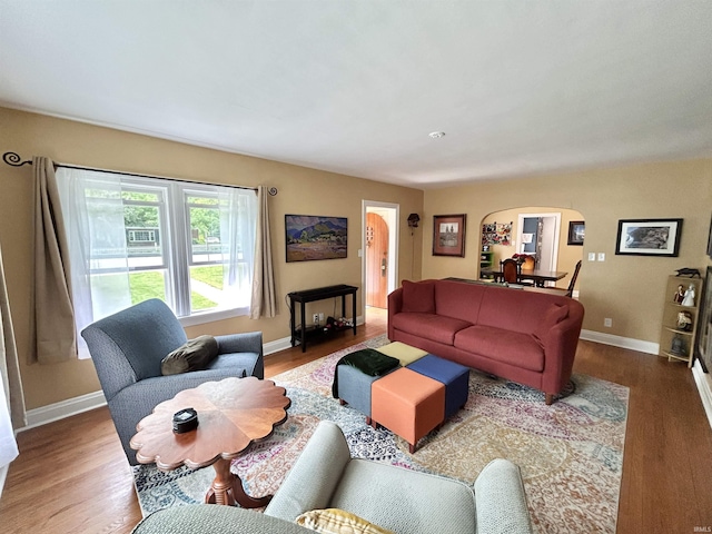 1500 N Grant St, West Lafayette, IN 47906 - living room featuring arched walkways, wood finished floors, and baseboards