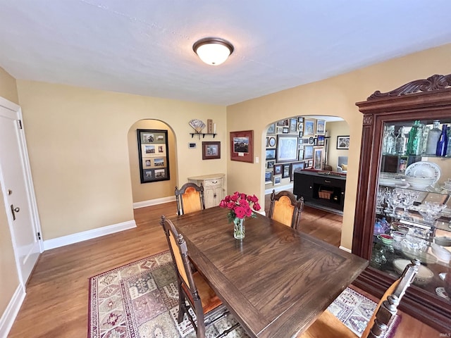 1500 N Grant St, West Lafayette, IN 47906 - dining area with arched walkways, wood finished floors, and baseboards