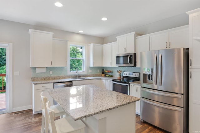 810 Tawny Dr, Evansville, IN 47712 - kitchen with appliances with stainless steel finishes, a sink, backsplash, white cabinets, and recessed lighting