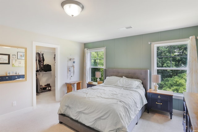 810 Tawny Dr, Evansville, IN 47712 - bedroom featuring a walk in closet, light colored carpet, a closet, and baseboards