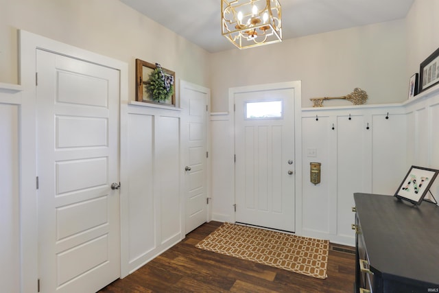 810 Tawny Dr, Evansville, IN 47712 - foyer entrance with a chandelier, dark wood-style floors, and a wainscoted wall