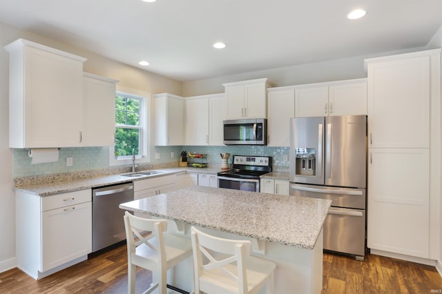 810 Tawny Dr, Evansville, IN 47712 - kitchen featuring stainless steel appliances, a sink, dark wood-type flooring, white cabinetry, and recessed lighting