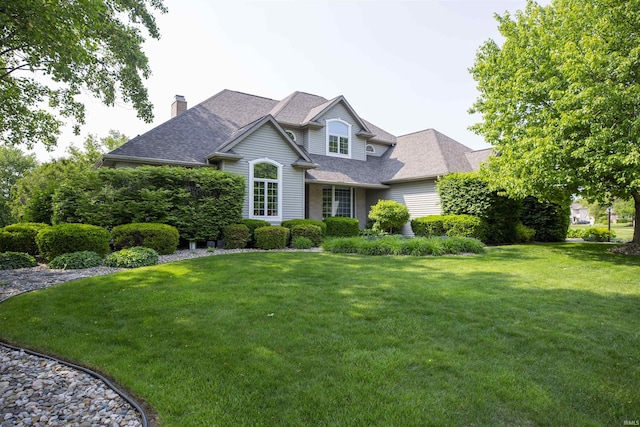 50661 Hedgewood Ct, Granger, IN 46530 - traditional-style home featuring a front yard, a chimney, and roof with shingles