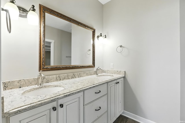 13769 Montoro Ct, Fort Wayne, IN 46845 - full bathroom featuring double vanity, baseboards, and wood finished floors