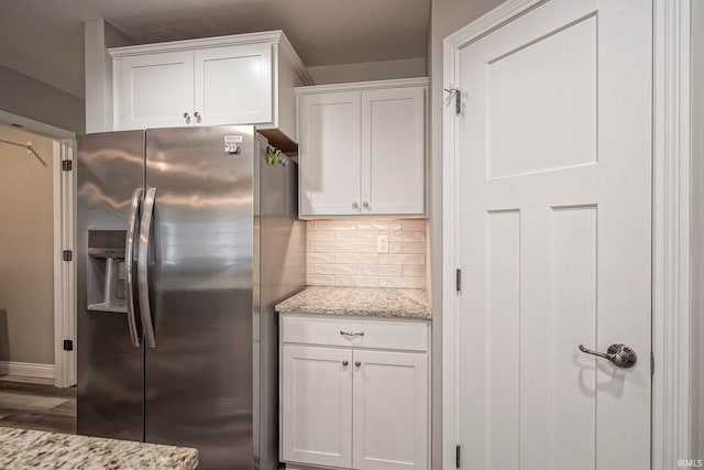 1757 Mill Pond Ln, Lafayette, IN 47905 - kitchen featuring stainless steel fridge, white cabinetry, tasteful backsplash, light stone countertops, and wood finished floors