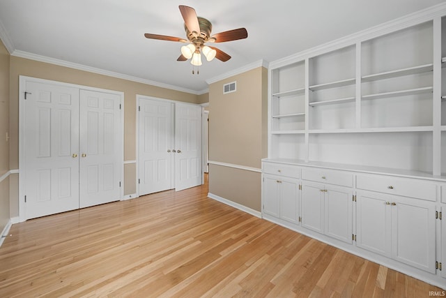 201 Colony Rd, West Lafayette, IN 47906 - unfurnished bedroom featuring two closets, light wood-style floors, crown molding, baseboards, and ceiling fan