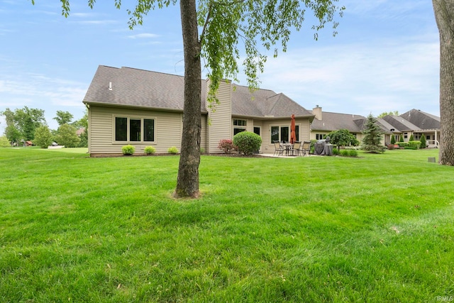 15829 Winterberry Ct, Huntertown, IN 46748 - rear view of house with a yard, a patio, and a chimney
