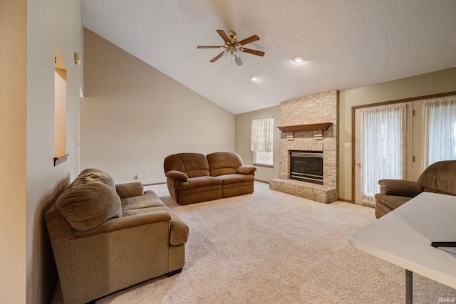 8633 State Rd 28 E, Clarks Hill, IN 47930 - living area featuring ceiling fan, carpet floors, lofted ceiling, a fireplace, and a textured ceiling