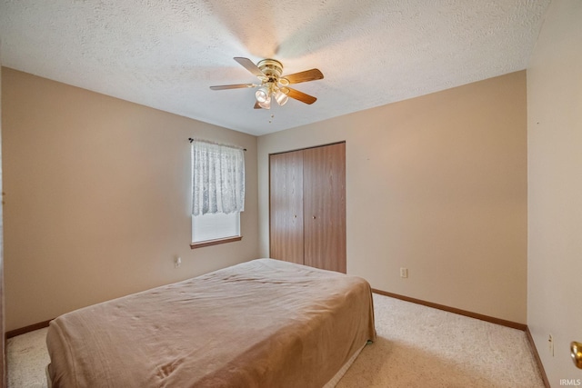 8633 State Rd 28 E, Clarks Hill, IN 47930 - carpeted bedroom with a closet, baseboards, a ceiling fan, and a textured ceiling