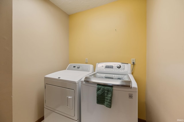 8633 State Rd 28 E, Clarks Hill, IN 47930 - laundry area featuring separate washer and dryer and a textured ceiling