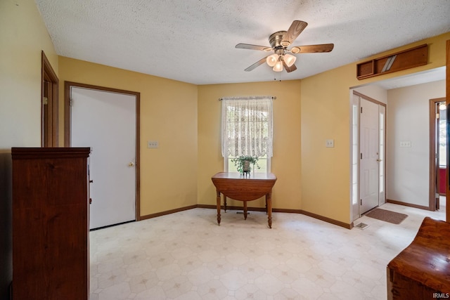 8633 State Rd 28 E, Clarks Hill, IN 47930 - entrance foyer with light flooring, a ceiling fan, a textured ceiling, and baseboards