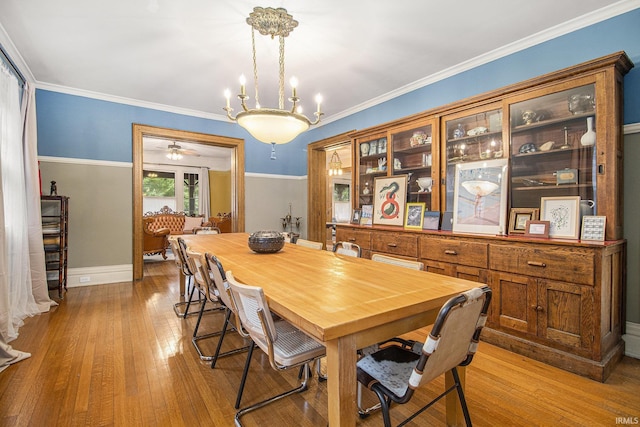 831 W Colfax Ave, South Bend, IN 46601 - dining area featuring wood finished floors, baseboards, ceiling fan, a chandelier, and ornamental molding