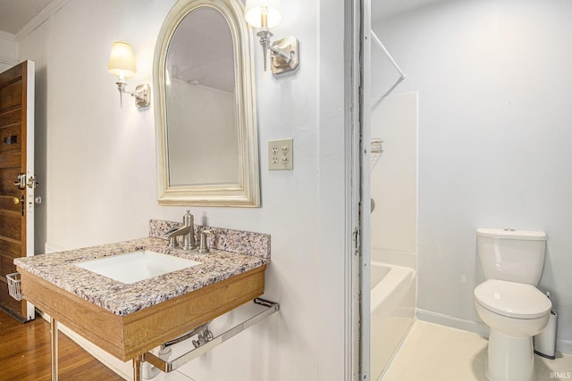 831 W Colfax Ave, South Bend, IN 46601 - full bath with toilet, vanity, wood finished floors, shower / bath combination, and baseboards