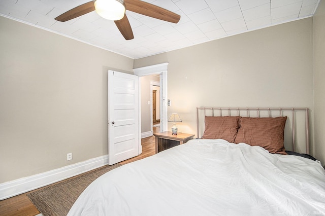 831 W Colfax Ave, South Bend, IN 46601 - bedroom featuring wood finished floors, a ceiling fan, baseboards, and ornamental molding
