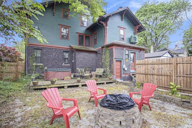 831 W Colfax Ave, South Bend, IN 46601 - rear view of property with a fire pit, a hot tub, a wooden deck, a fenced backyard, and a cooling unit