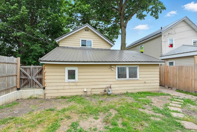 211 N Poplar St, Lagrange, IN 46761 - rear view of house featuring metal roof and a fenced backyard