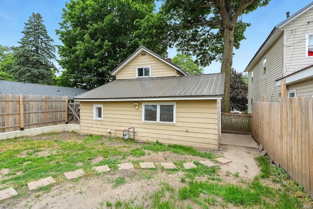 211 N Poplar St, Lagrange, IN 46761 - back of house featuring metal roof and a fenced backyard