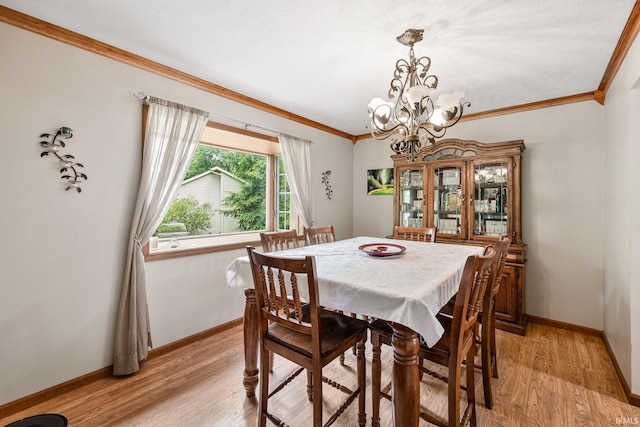 30986 Creekwood Ter, Osceola, IN 46561 - dining space featuring a chandelier, crown molding, light wood-style flooring, and baseboards