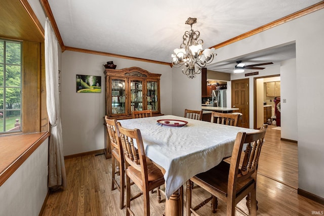 30986 Creekwood Ter, Osceola, IN 46561 - dining room with crown molding, baseboards, a chandelier, and wood finished floors