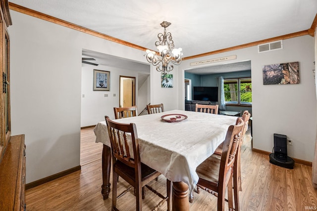 30986 Creekwood Ter, Osceola, IN 46561 - dining space with baseboards, crown molding, light wood-style floors, and a chandelier