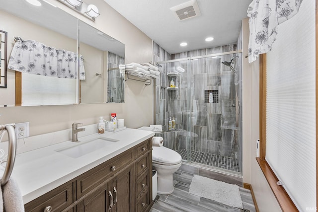 30986 Creekwood Ter, Osceola, IN 46561 - bathroom featuring toilet, vanity, a shower stall, wood finished floors, and recessed lighting