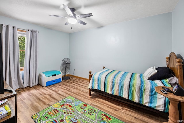 30986 Creekwood Ter, Osceola, IN 46561 - bedroom with light wood-style floors, a ceiling fan, and baseboards