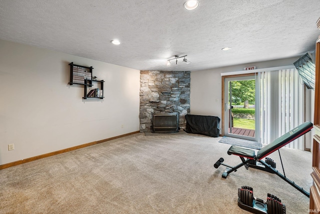 30986 Creekwood Ter, Osceola, IN 46561 - exercise room with carpet floors, baseboards, a textured ceiling, recessed lighting, and a stone fireplace