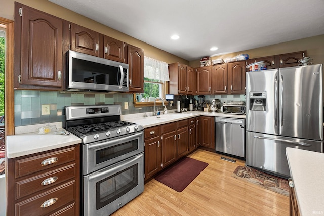 30986 Creekwood Ter, Osceola, IN 46561 - kitchen with appliances with stainless steel finishes, a sink, light wood-type flooring, light countertops, and recessed lighting