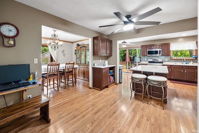 30986 Creekwood Ter, Osceola, IN 46561 - kitchen with stainless steel appliances, light countertops, a ceiling fan, and light wood-style flooring