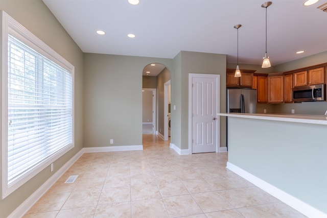 9081 Halston Cir, Newburgh, IN 47630 - kitchen featuring stainless steel appliances, plenty of natural light, arched walkways, brown cabinetry, and recessed lighting