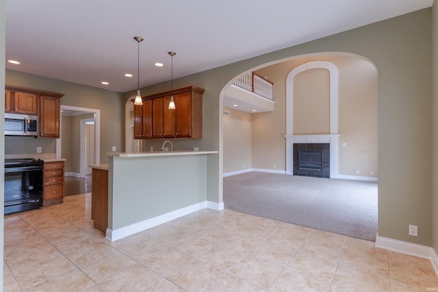 9081 Halston Cir, Newburgh, IN 47630 - kitchen with stainless steel microwave, black range with electric cooktop, light countertops, brown cabinets, and recessed lighting