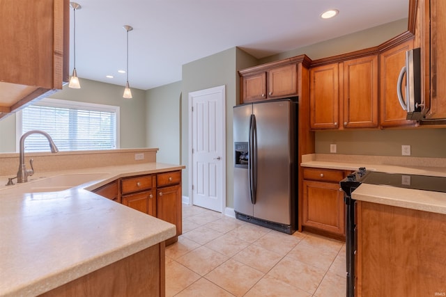 9081 Halston Cir, Newburgh, IN 47630 - kitchen featuring stainless steel appliances, a sink, brown cabinetry, decorative light fixtures, and light tile patterned floors