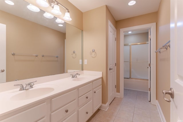9081 Halston Cir, Newburgh, IN 47630 - bathroom with tile patterned floors, double vanity, baseboards, bath / shower combo with glass door, and recessed lighting
