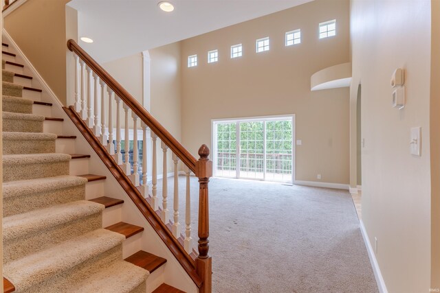 9081 Halston Cir, Newburgh, IN 47630 - stairway with carpet, a high ceiling, baseboards, and recessed lighting