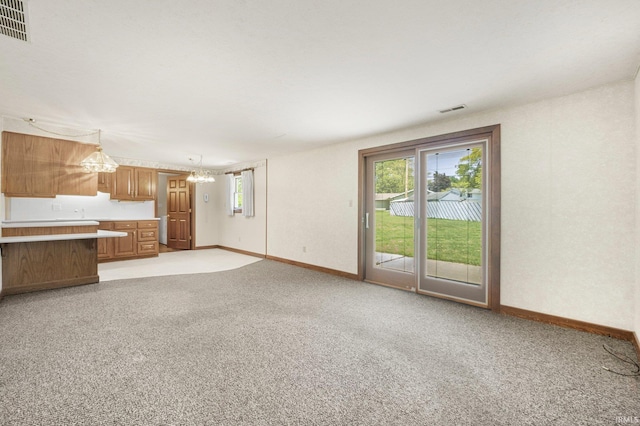 120 Cord Pl, Auburn, IN 46706 - unfurnished living room with baseboards, a chandelier, and light colored carpet